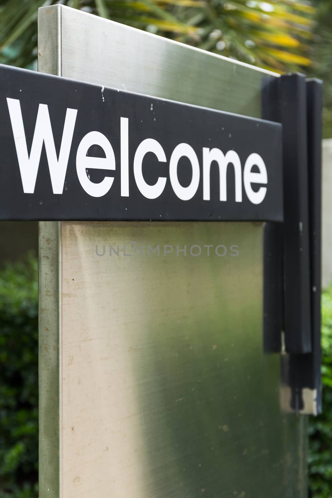 Welcome sign greeting visitor in front of the gate.