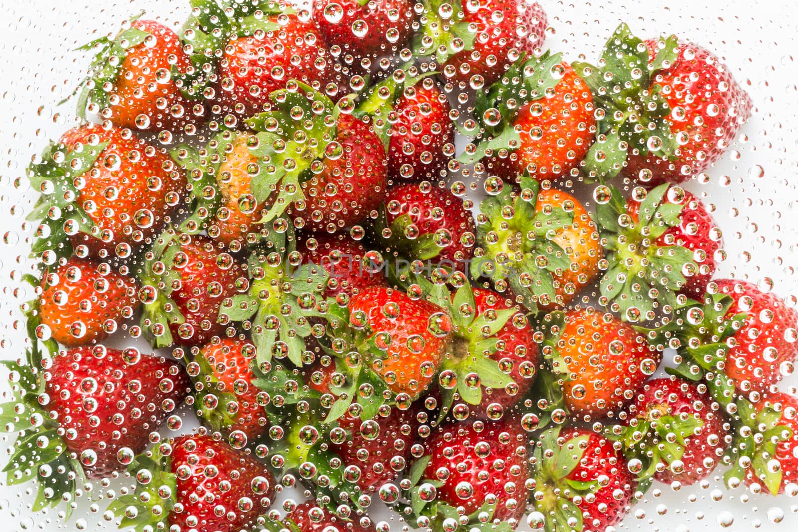 Water drop, droplet, raindrop of strawberry background