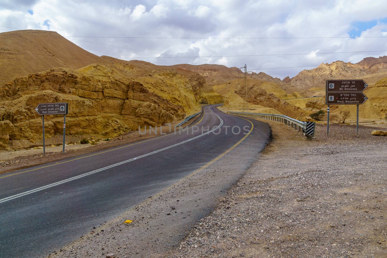 View of the Nahal Shlomo (desert valley), with direction sign. Eilat Mountains, southern Israel. Logo in non-commercial (National Nature Reserves Authority)