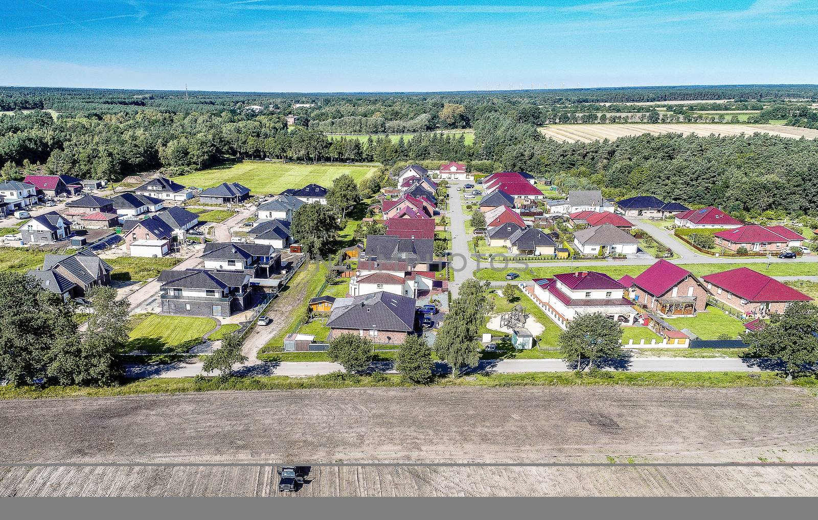 Aerial photo with the drone, anew build-up plot with single houses and gardens, narrow neighborhood