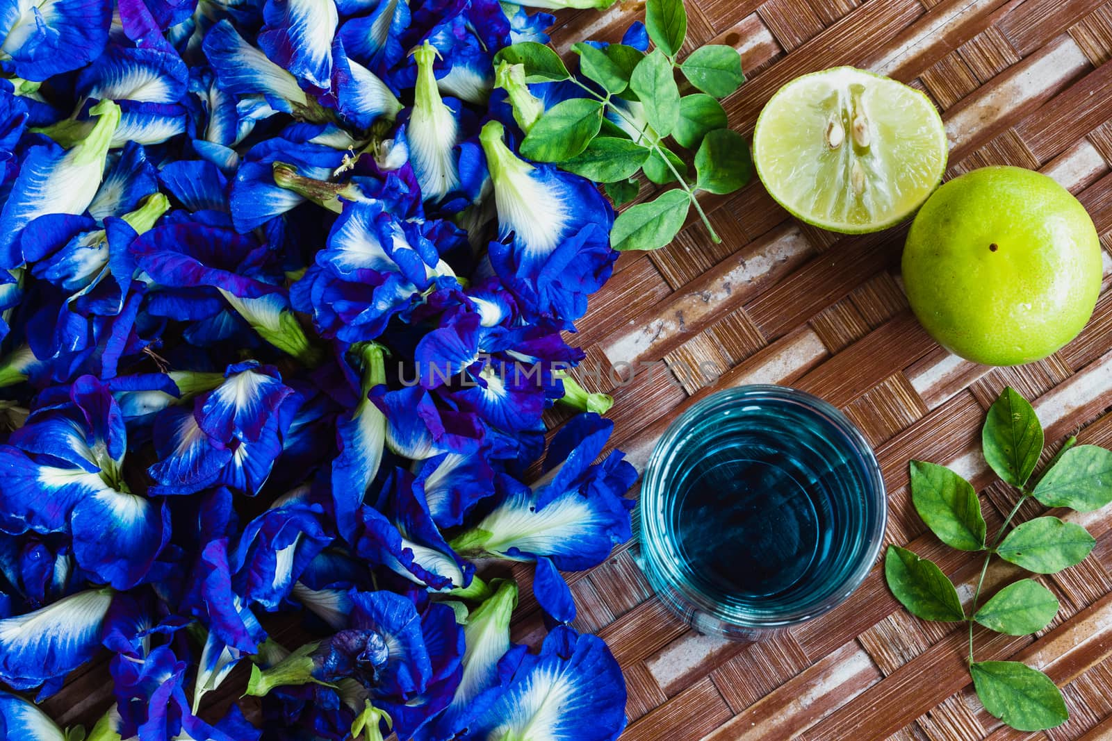 fresh butterfly pea flowera in bamboo tray by Khankeawsanan