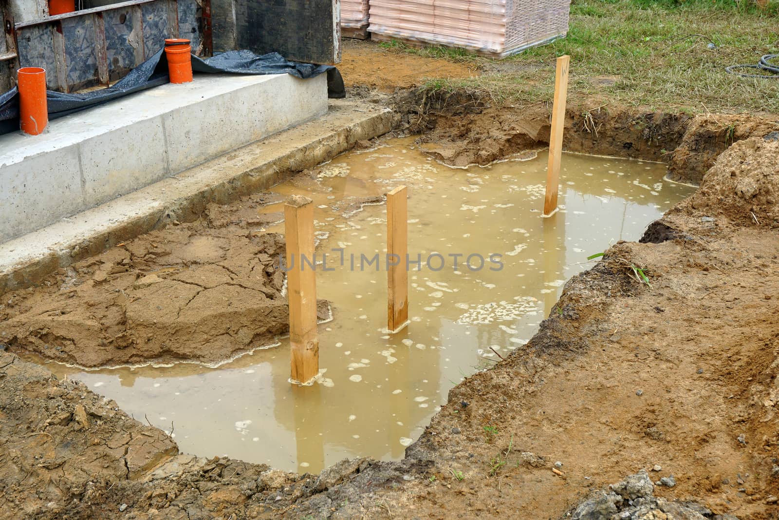 Excavation pit, filled with ground water, construction site