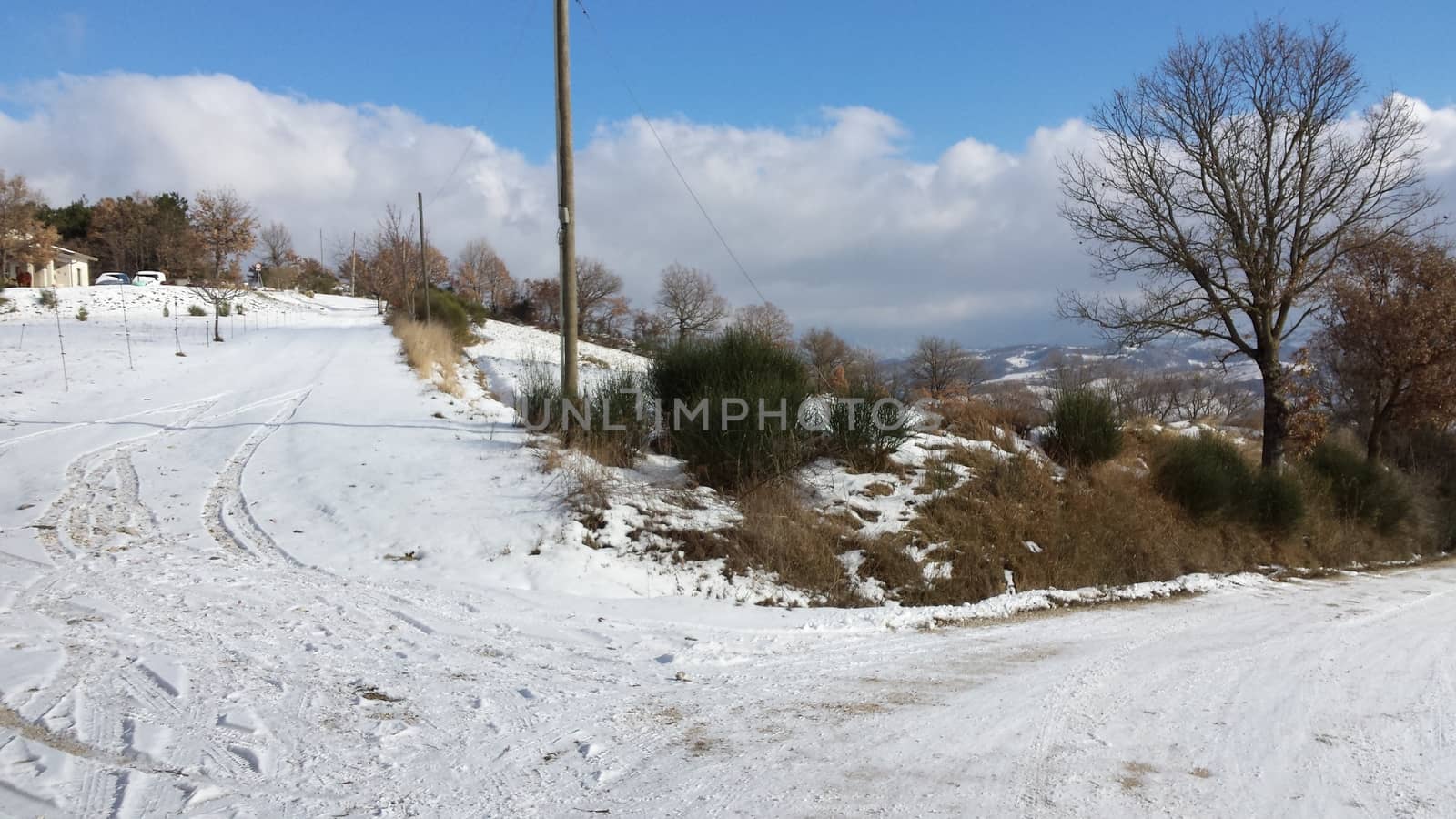 The countryside of Umbria near to Gubbio under the snow during the Winter - Beautiful landscape covered by snow in a sunny day by matteobartolini