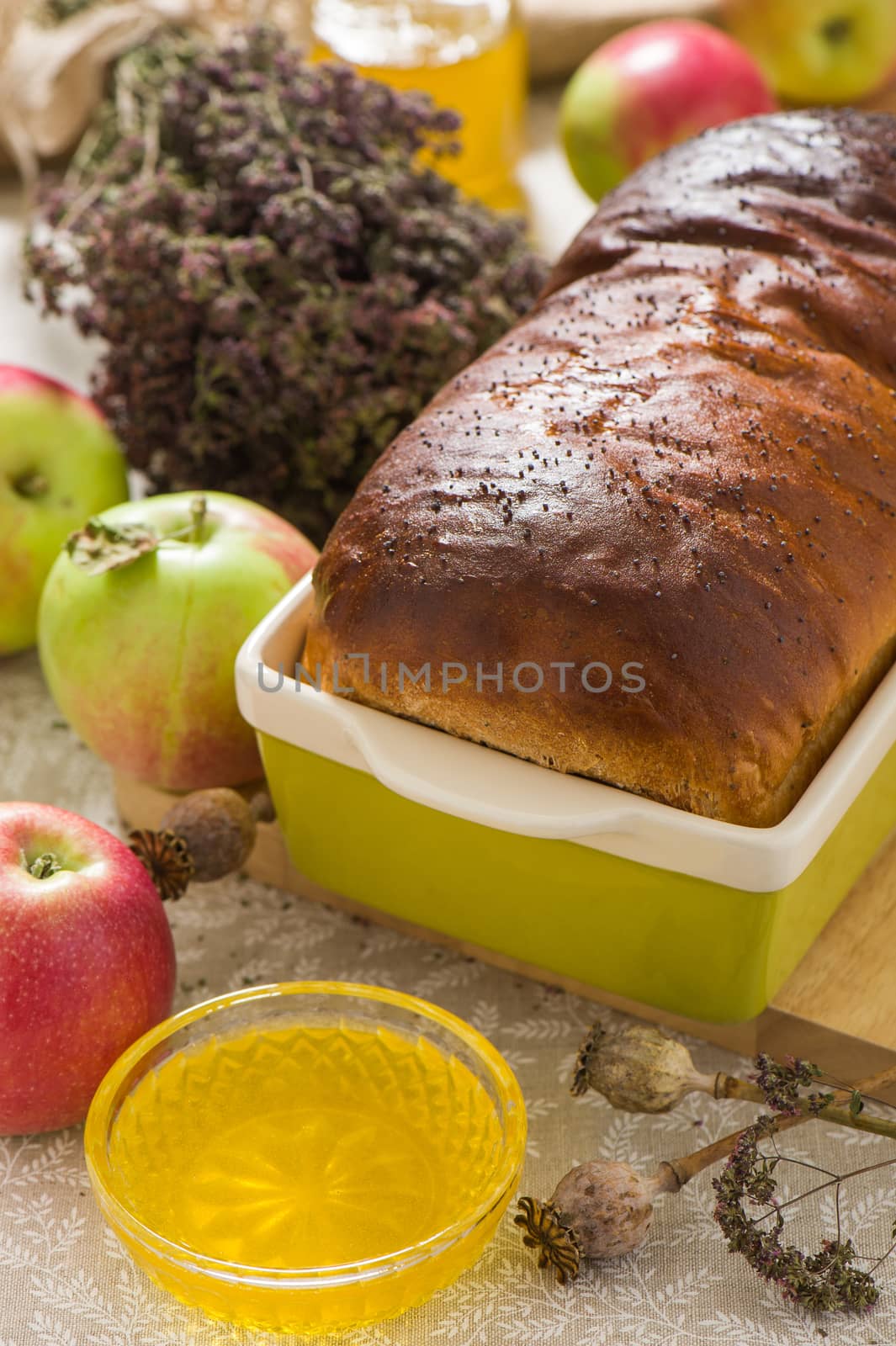 Homemade bread with poppy seeds with honey and apples