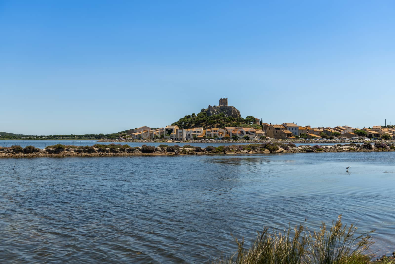 Old town of Gruissan and its Barbarossa tower and its ponds, in the south of France in Occitanie. by Frederic