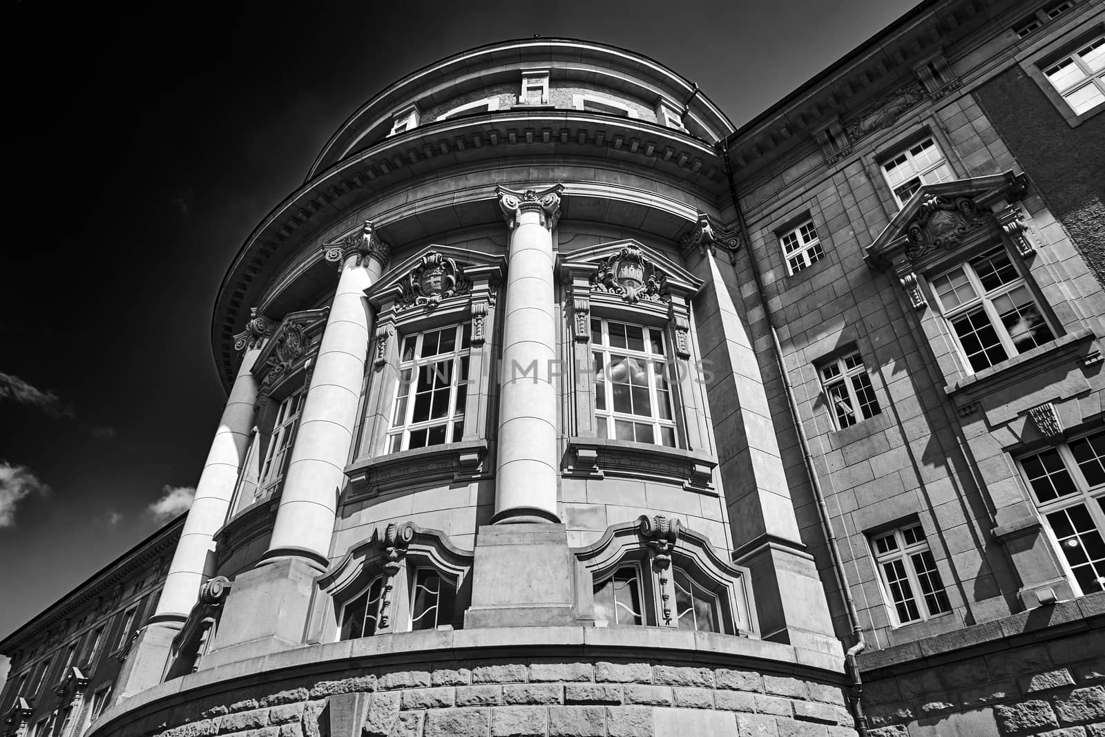 Facade of a historic  Neo-Baroque building with columns  in Poznan, black and white