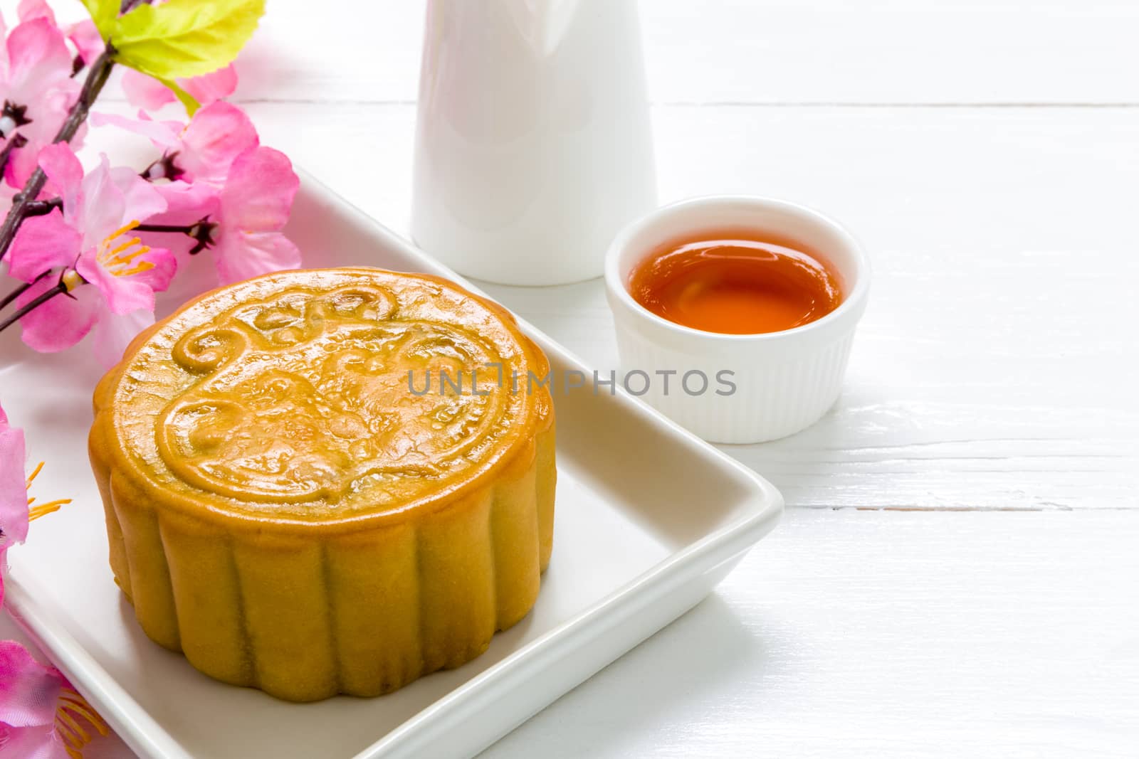 Traditional Chinese mooncake eaten with hot tea for relaxing time.