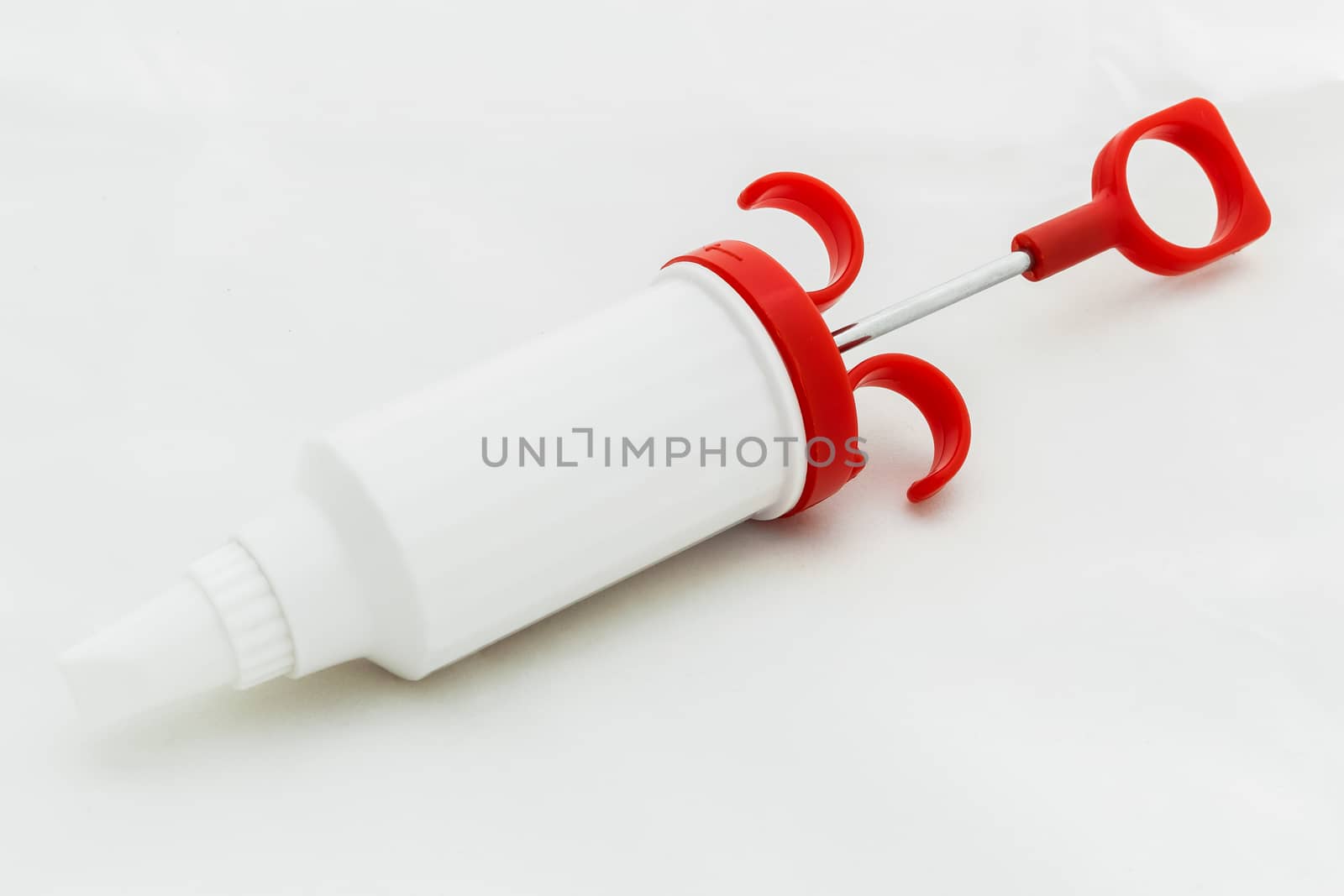 Icing syringe isolated on white background.