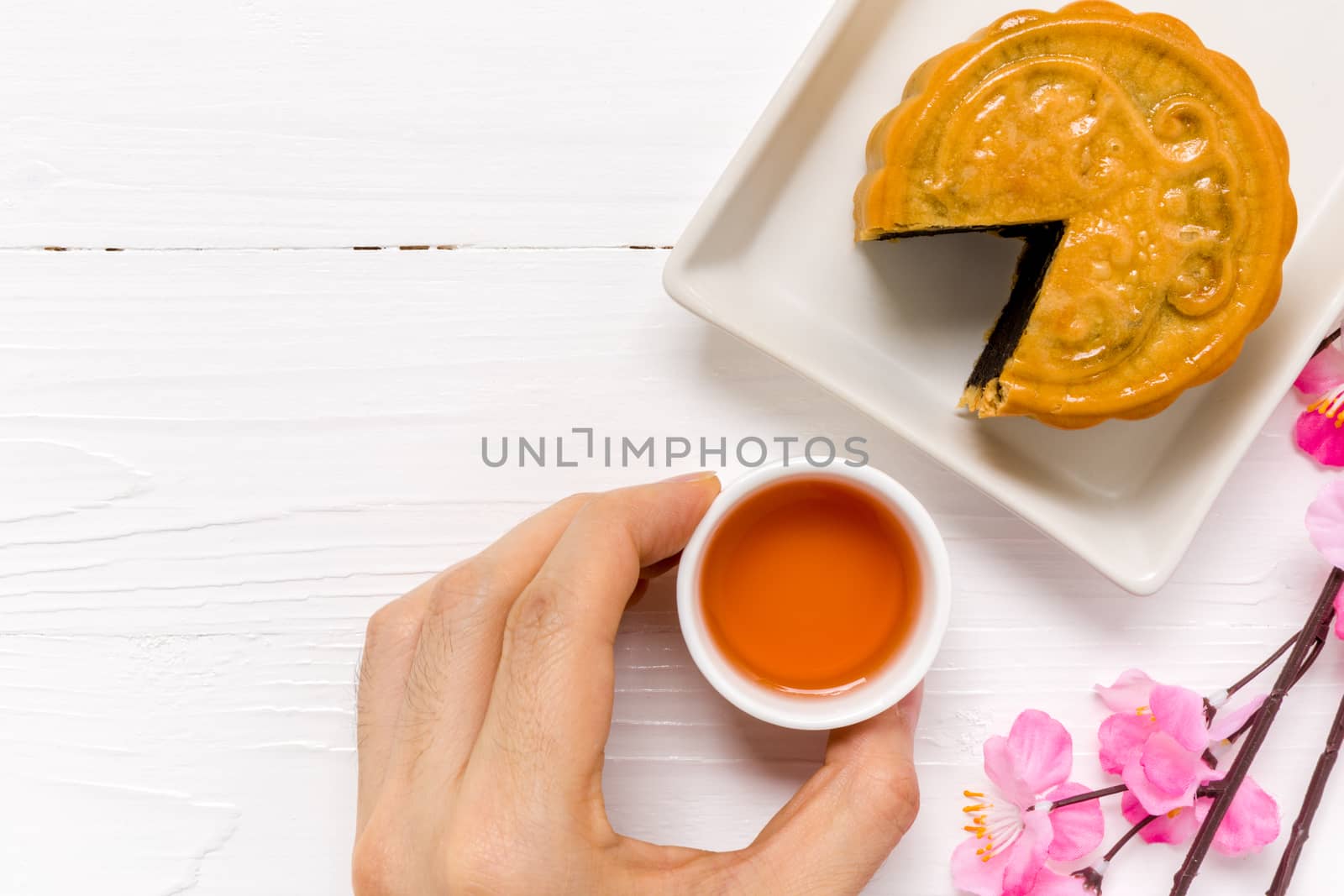 Traditional Chinese mooncake eaten with hot tea for relaxing time.
