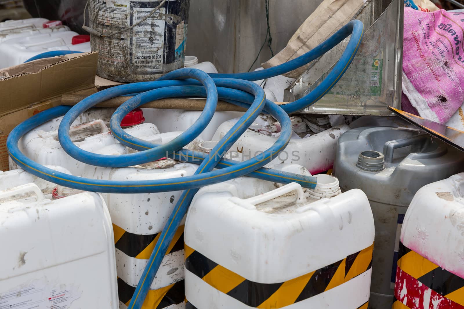 Big pile of empty dangerous chemical industry containers