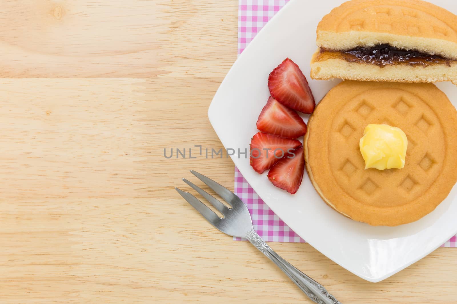 Background of waffle and tea on wooden table for tea break or coffee break.