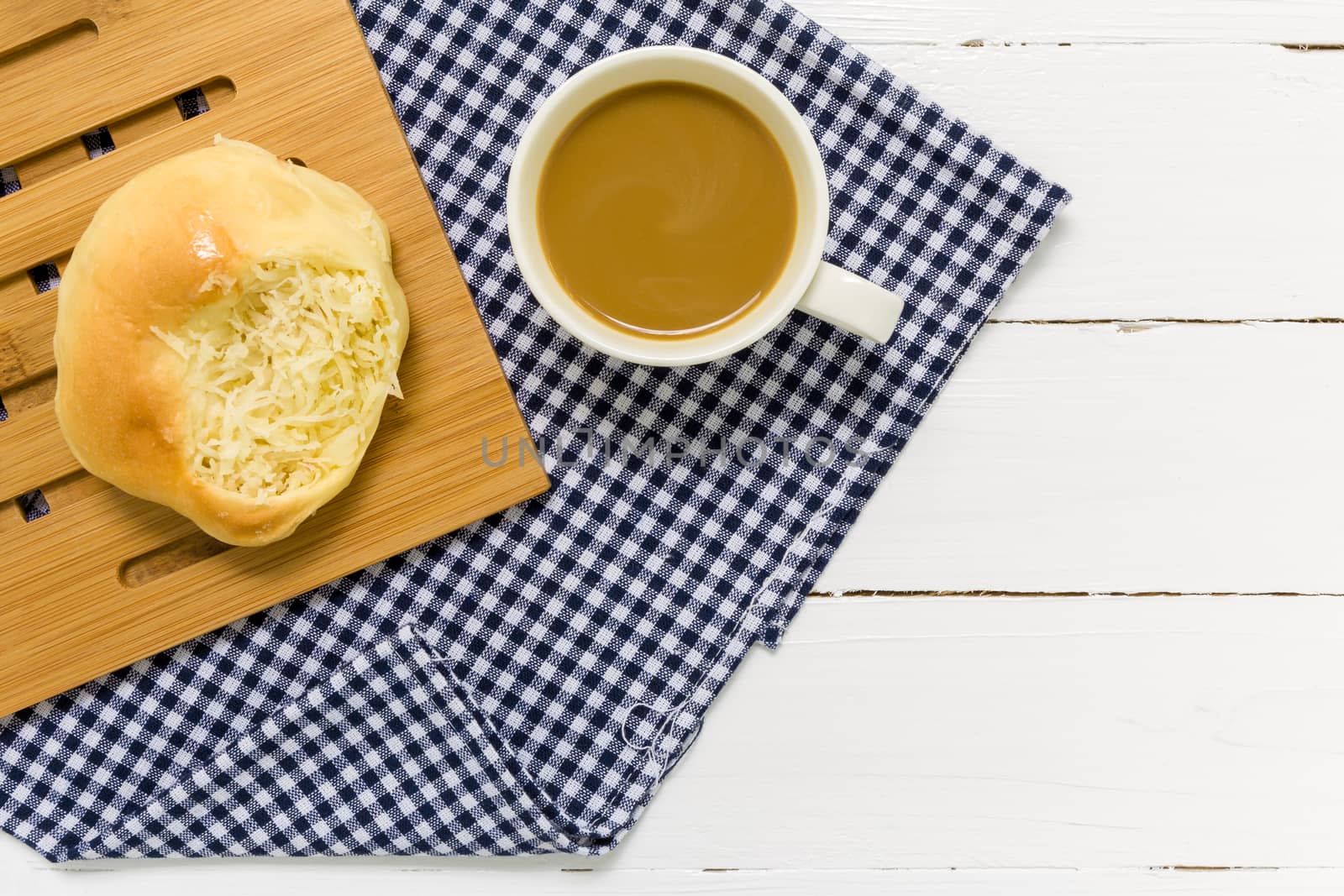 Coconut bun with cup of coffee for breakfast background.