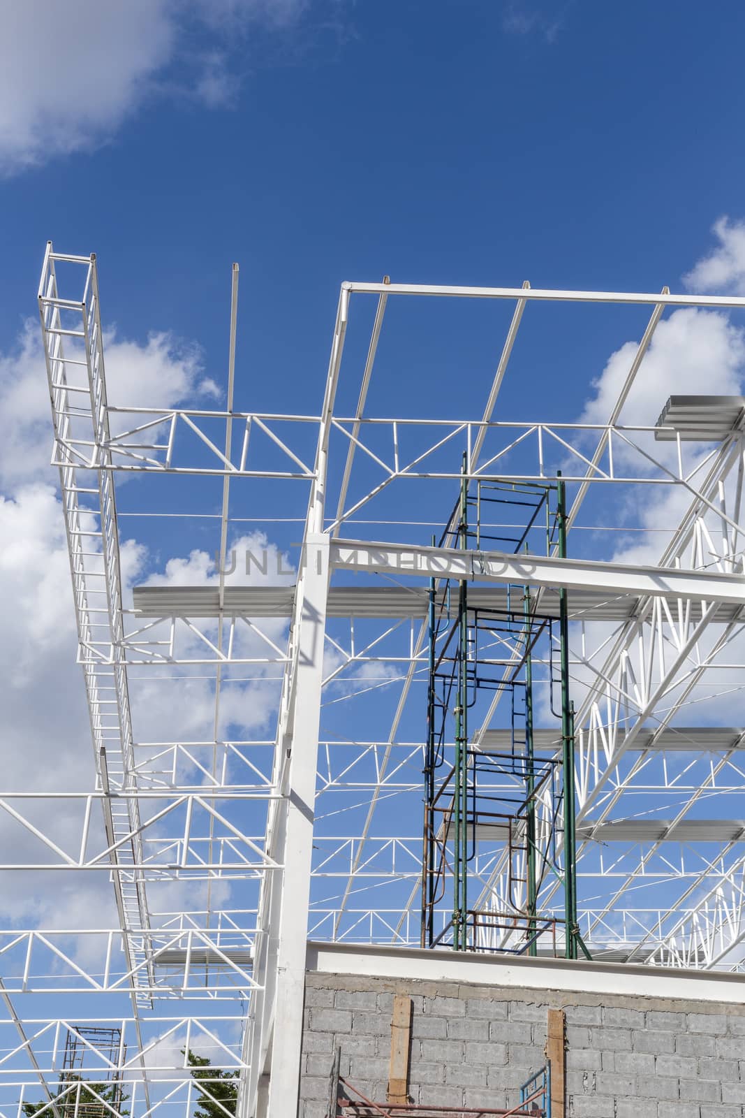 Construction of steel frame of big building with blue sky background.