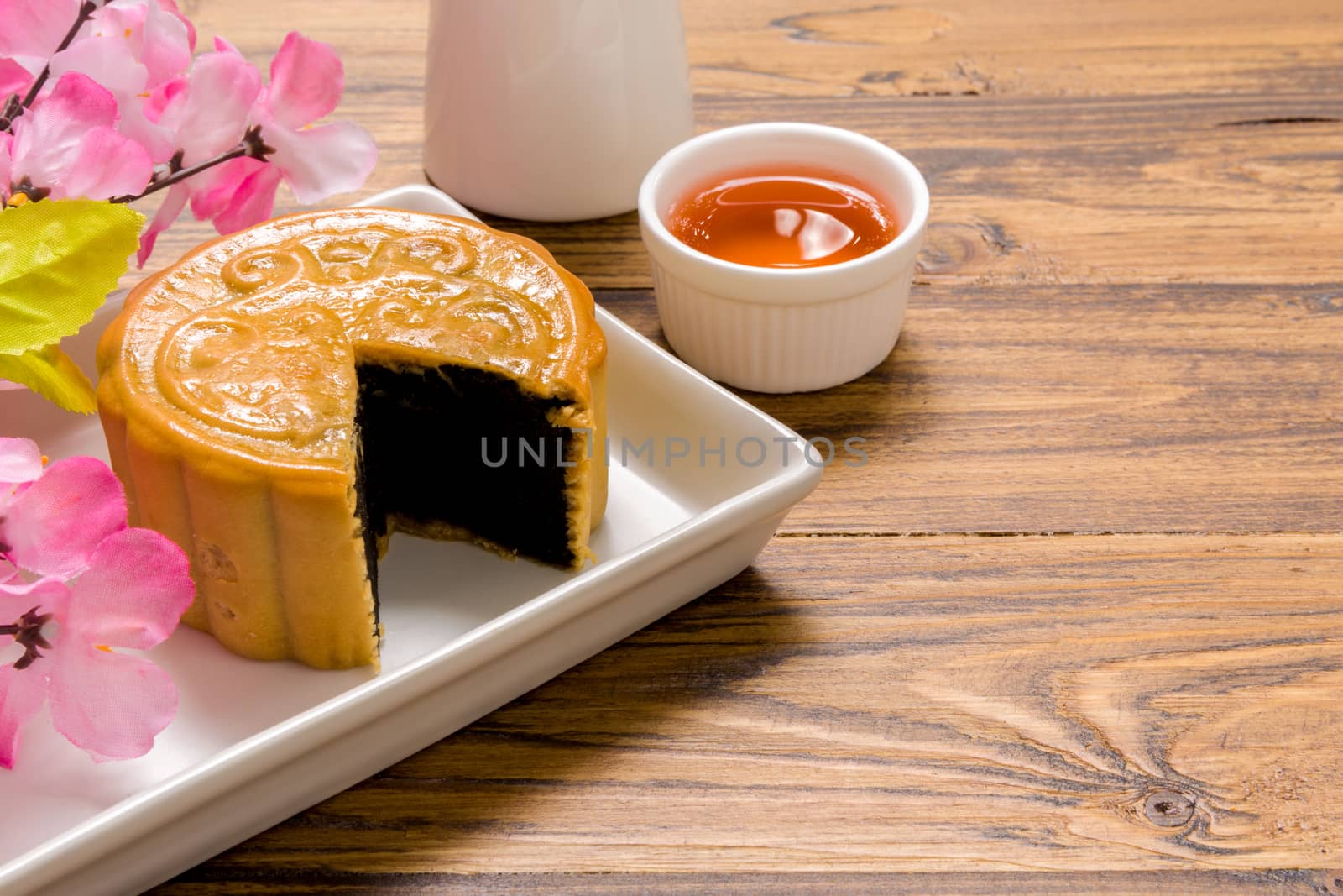 Traditional Chinese mooncake eaten with hot tea for relaxing time.