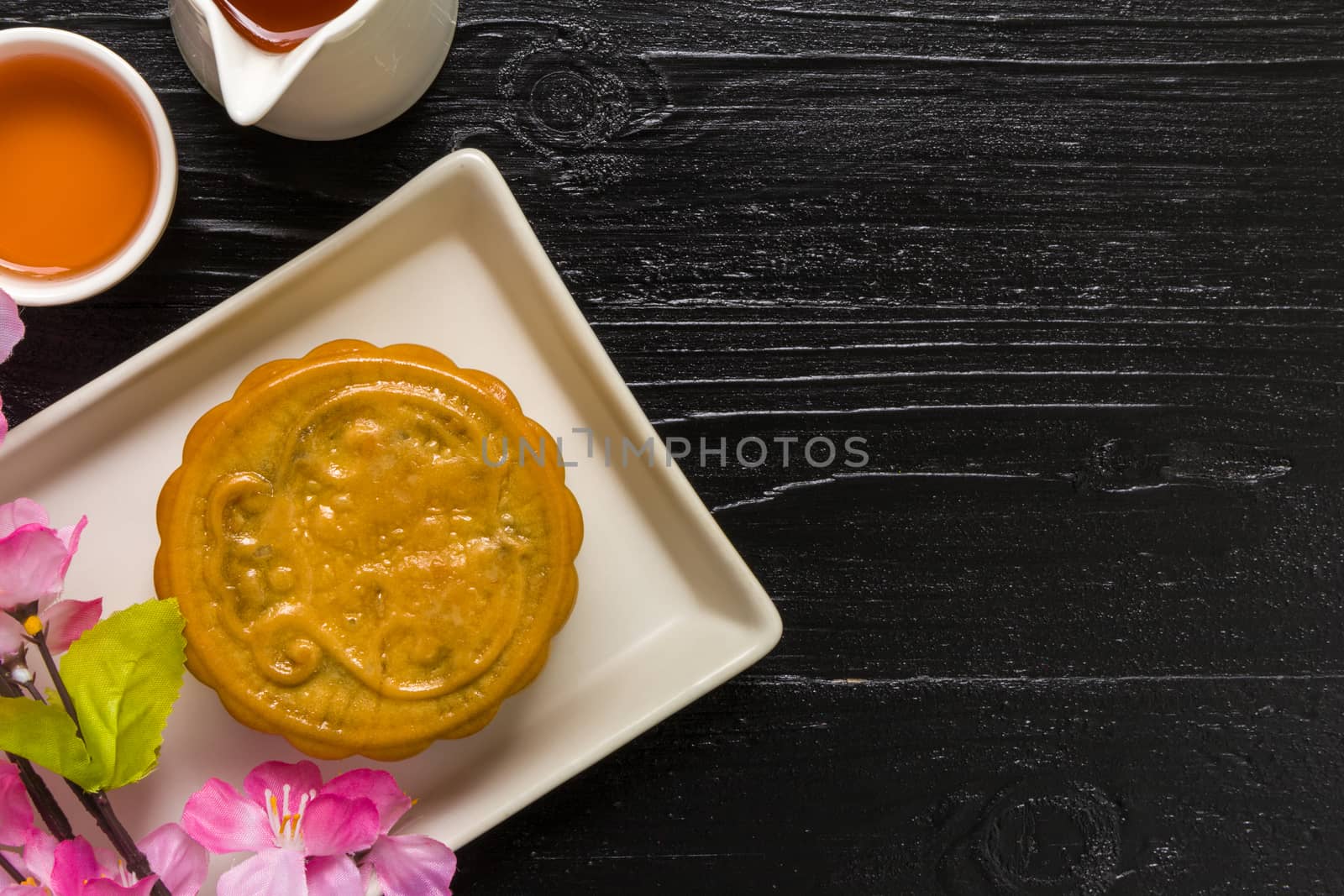 Traditional Chinese mooncake eaten with hot tea for relaxing time.