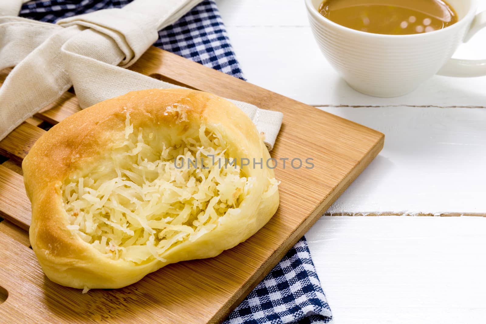 Coconut bun with cup of coffee for breakfast background.