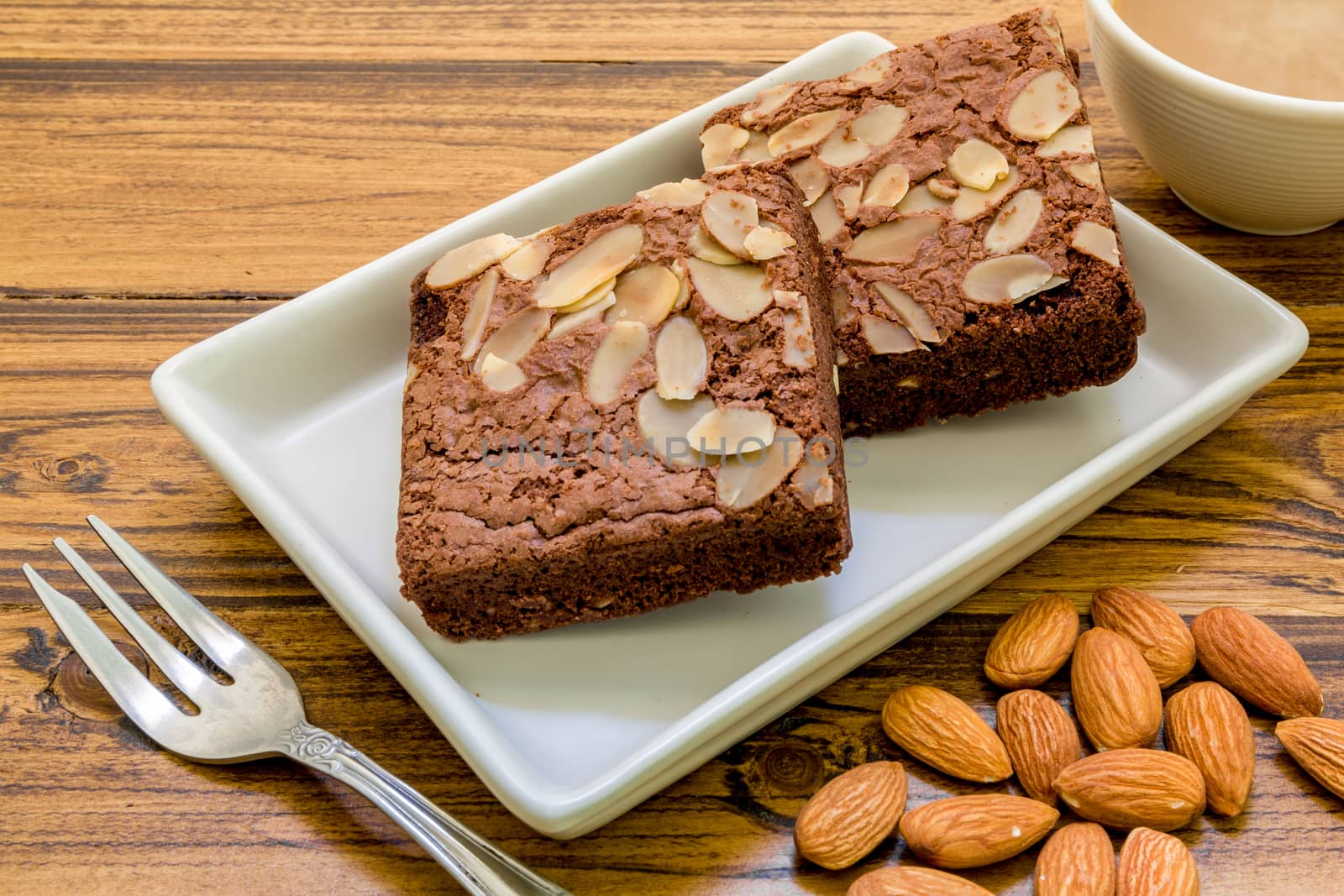 Chocolate almond brownie for relaxing coffee break.