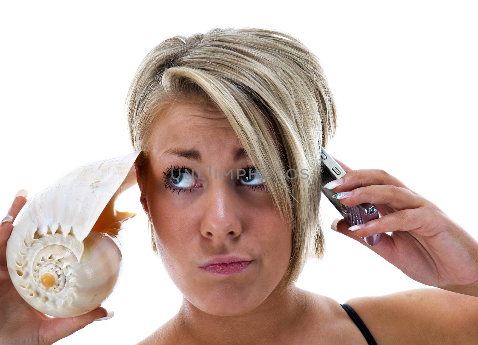 Young woman listening to conch shell and phone