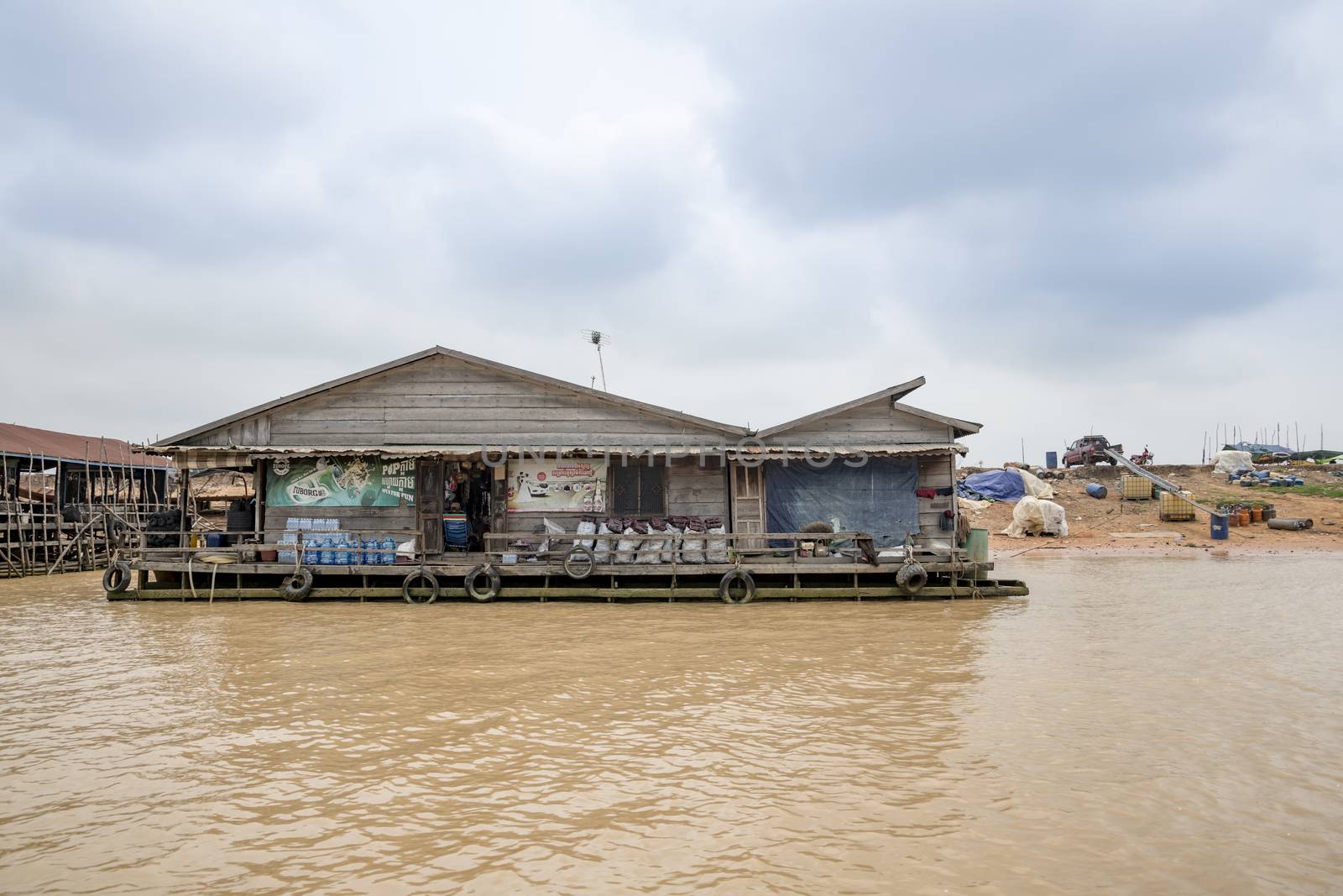 Building (home or grocery?) floating on Siem Reap river going to Tonle Sap lake, a famous tourist destination of Siem Reap Province, Cambodia