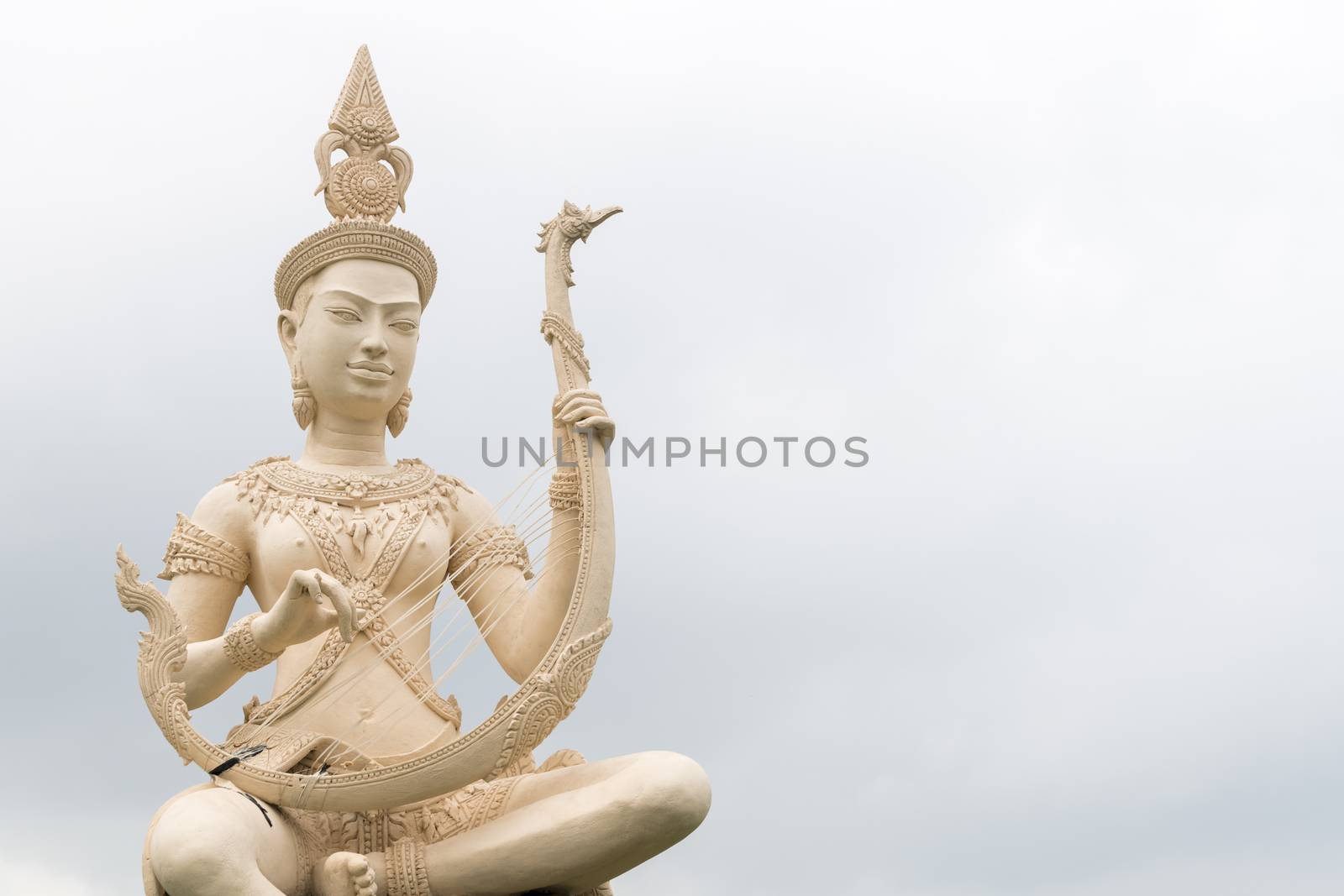 A classical Cambodian Goddess statue playing with a traditional harp along the sea at Kep, Cambodia, Asia