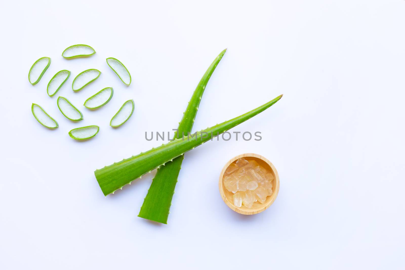 Aloe vera and slices with aloe vera gel in wooden bowl isolated on white background.