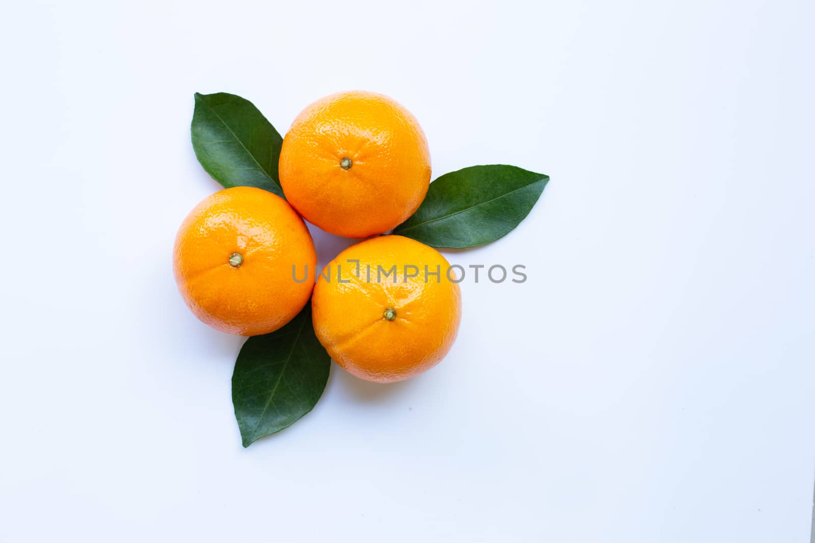 Fresh orange citrus fruit with leaves isolated on white background.  Top view