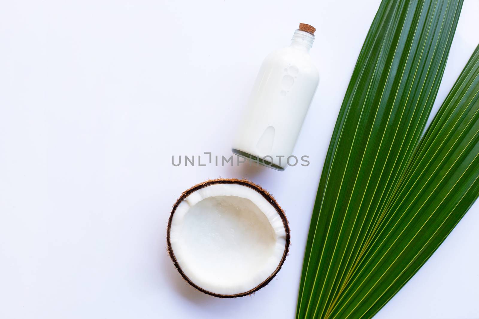 Coconut with coconut milk on white background