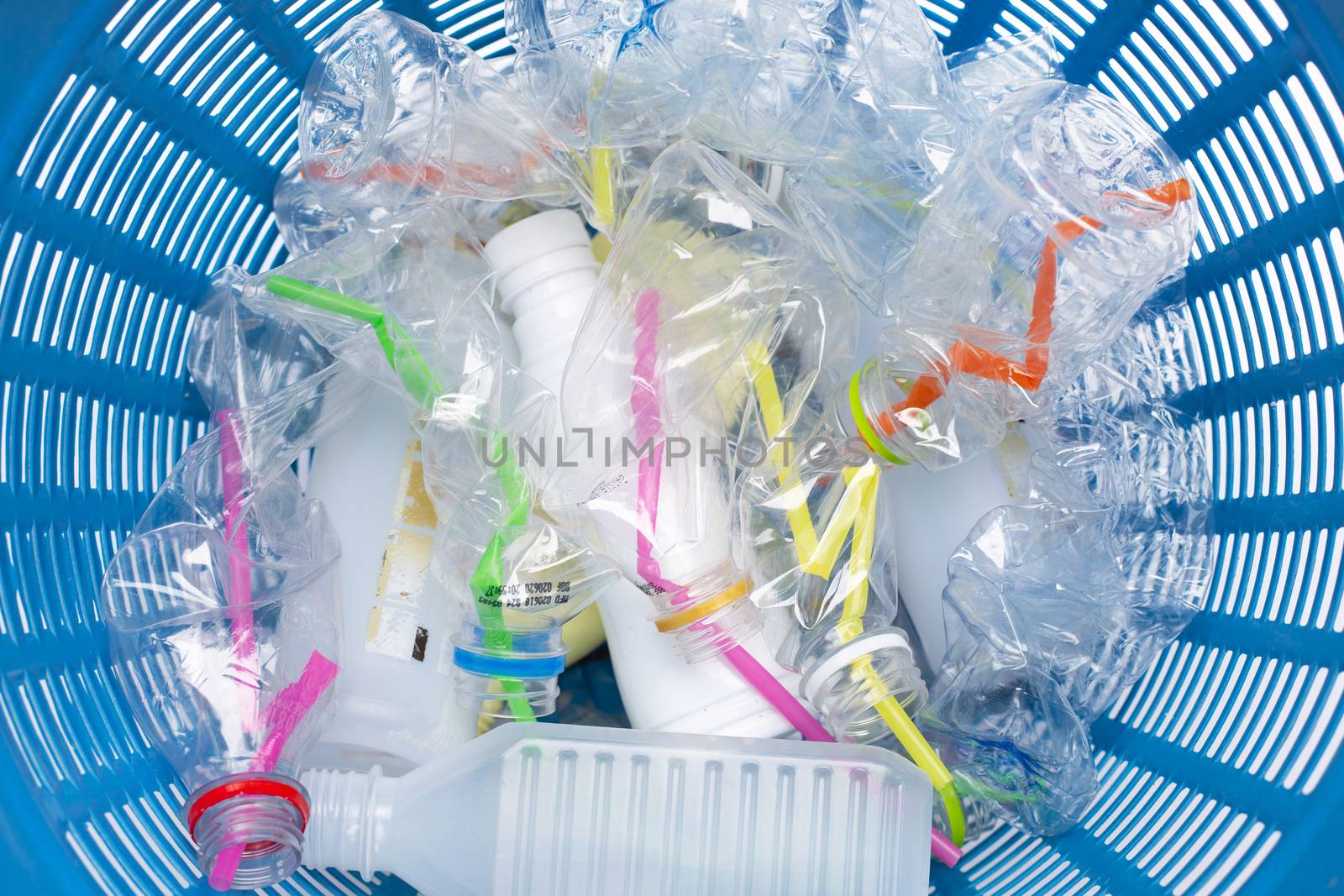 Plastic waste, Plastic bottles with straws in waste basket