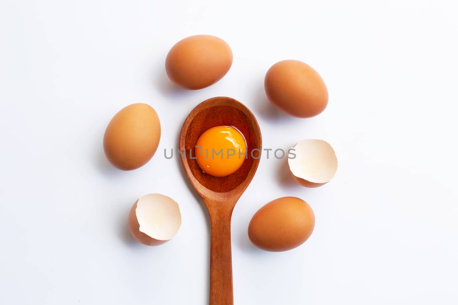 Chicken eggs with yolk on white background.