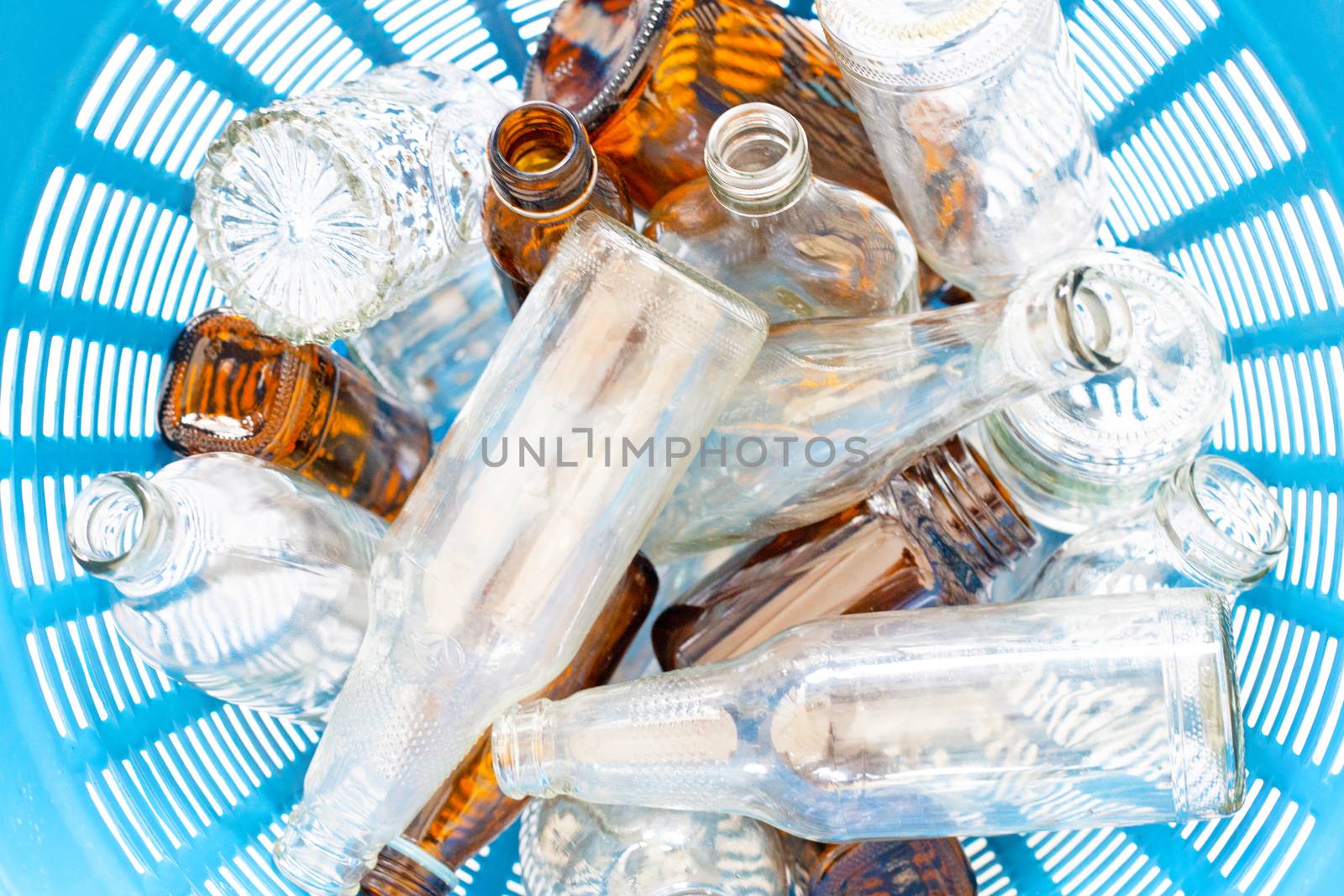 Glass bottles in waste basket. Top view