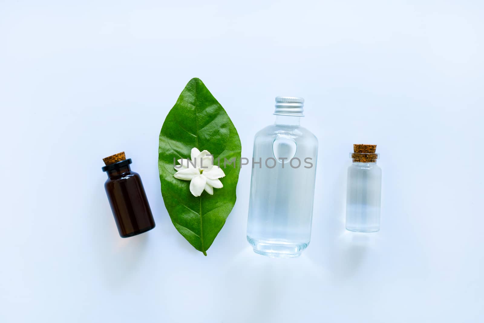 Essential oil with jasmine  flower on white background.
