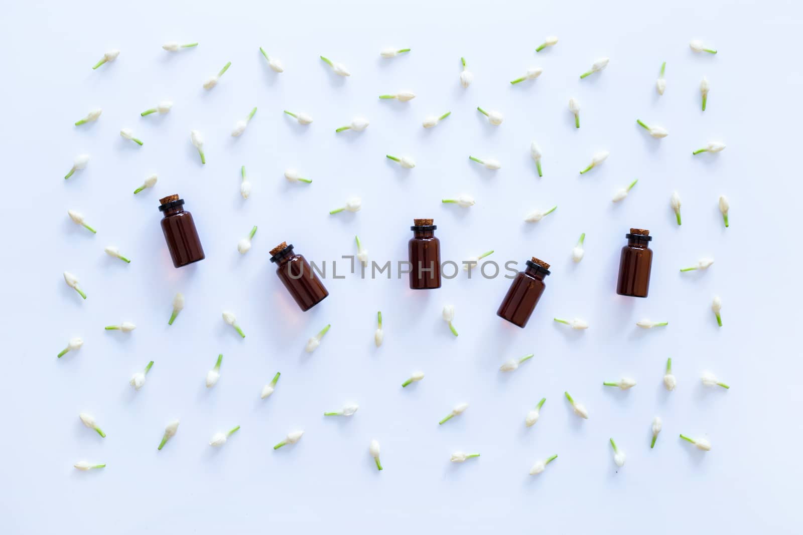 Essential oil with jasmine  flower on white background.