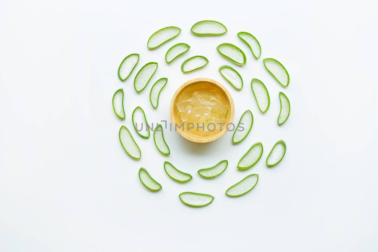 Aloe vera slices with aloe vera gel on wooden bowl isolated on white  background.