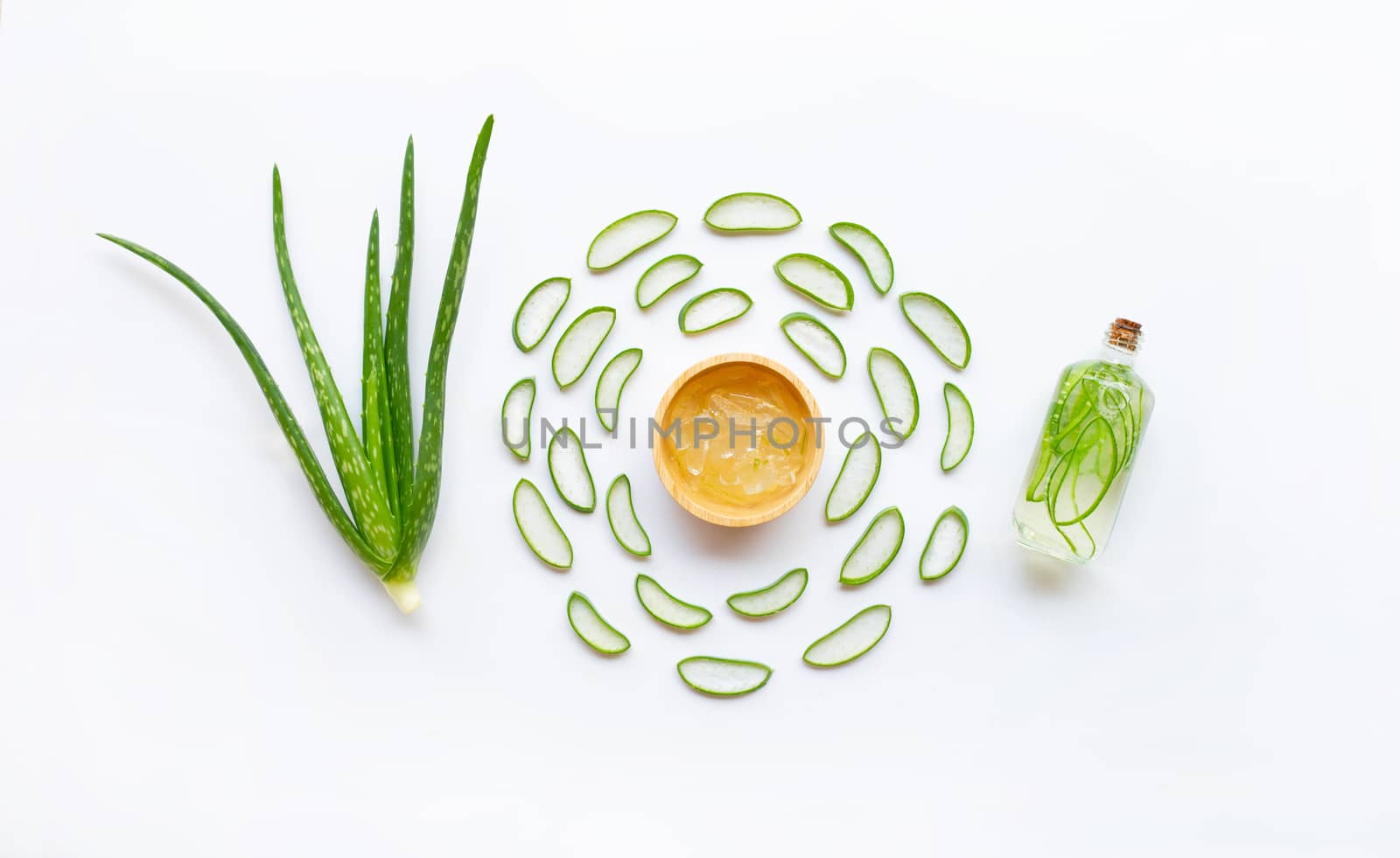 Aloe vera with slices and extract on white background.