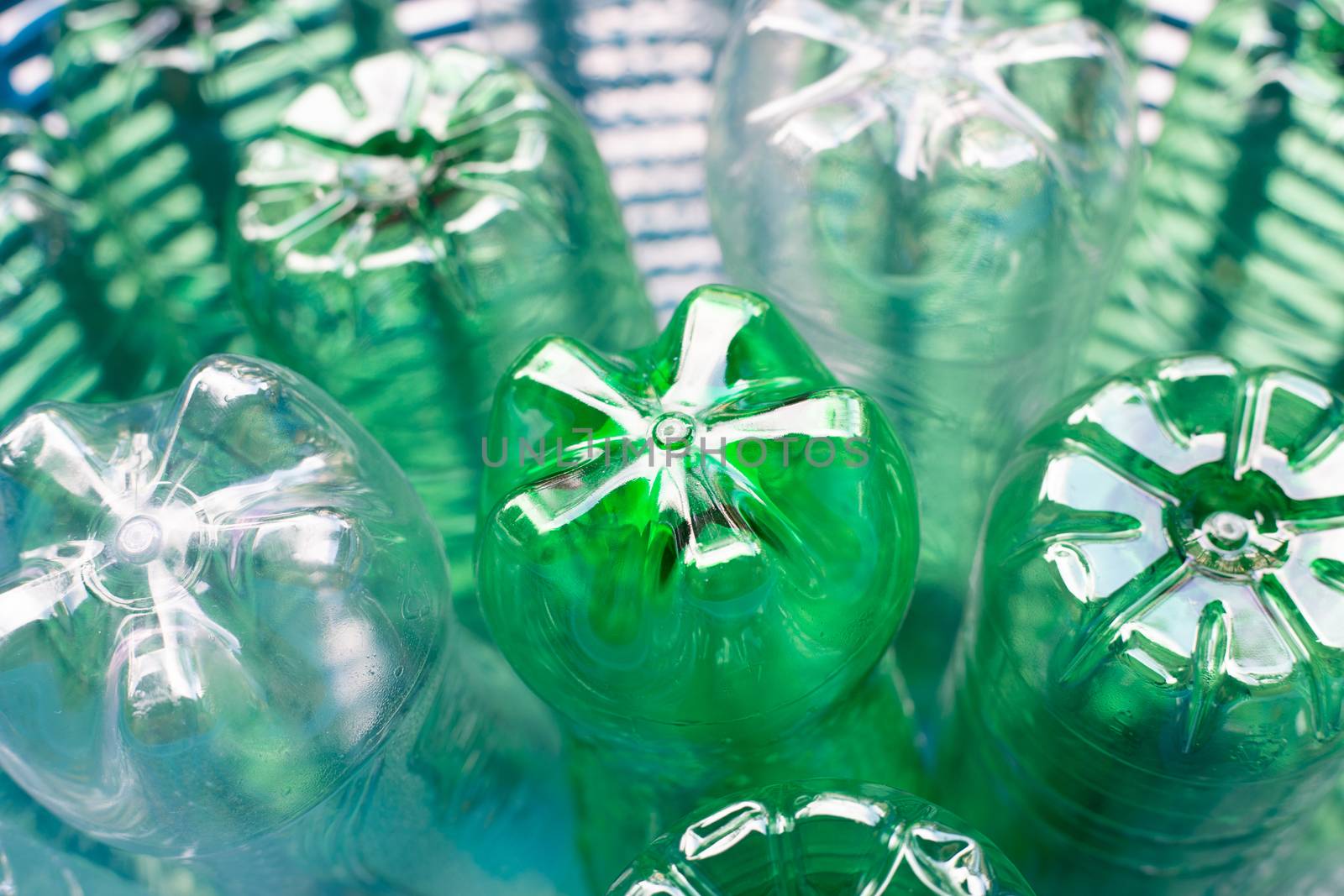 Plastic bottles in blue waste basket.