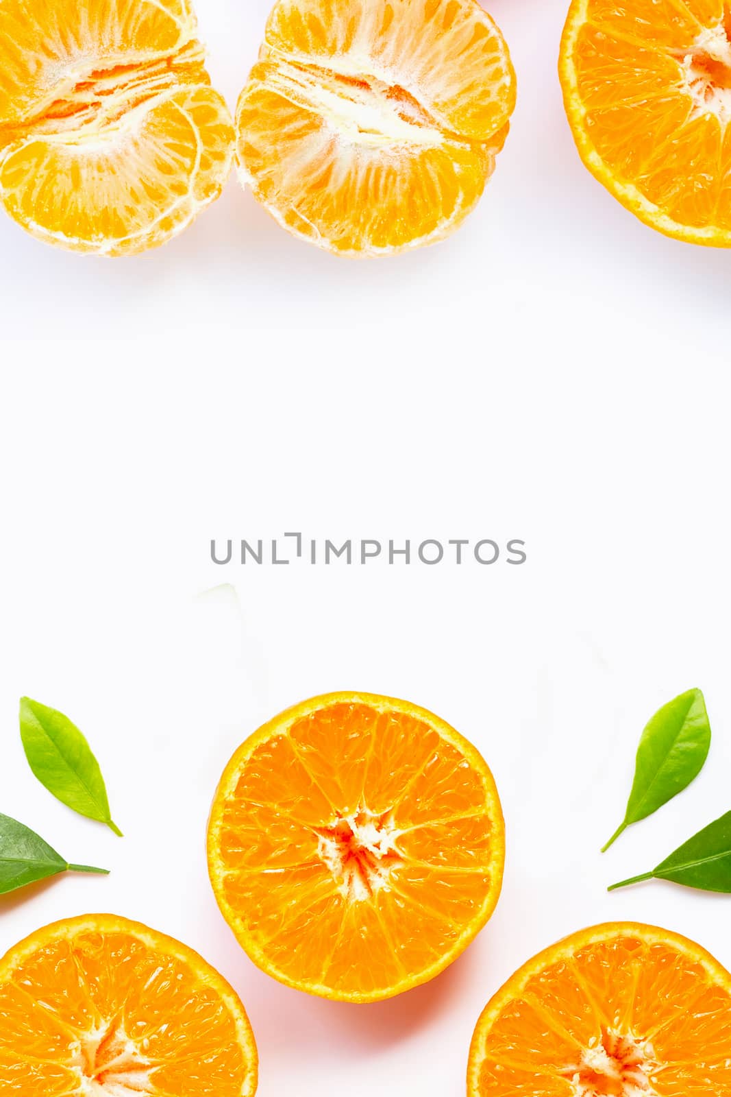Frame made of Orange with green leaves isolated on white background. Copy space