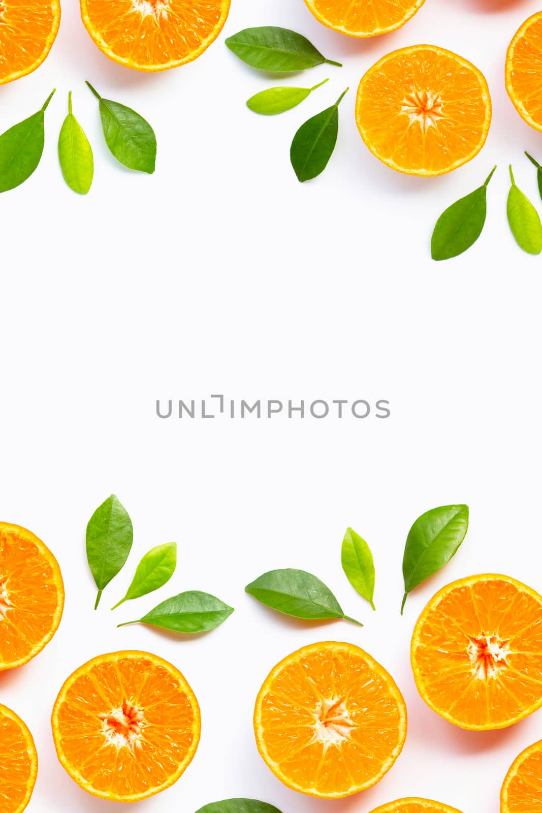 Frame made of Orange with green leaves isolated on white background. Copy space