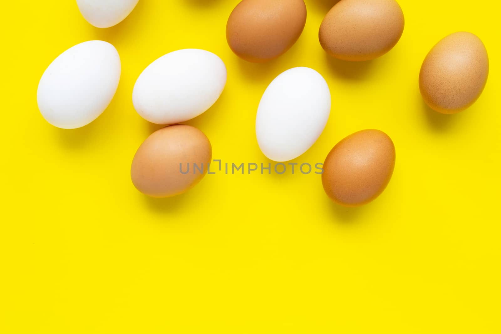 Eggs on yellow background.  Top view