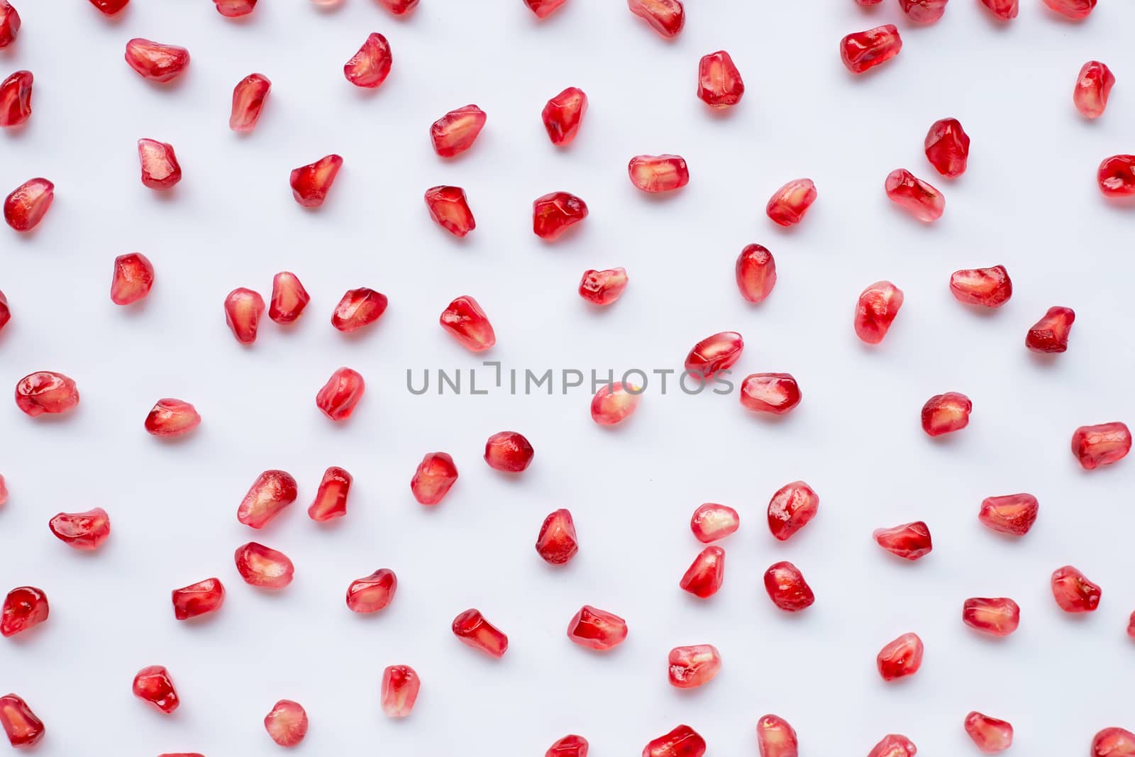 Pomegranate seeds on white background. Top view