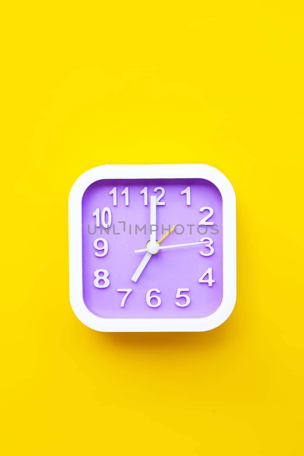 Clock on yellow background. Top view