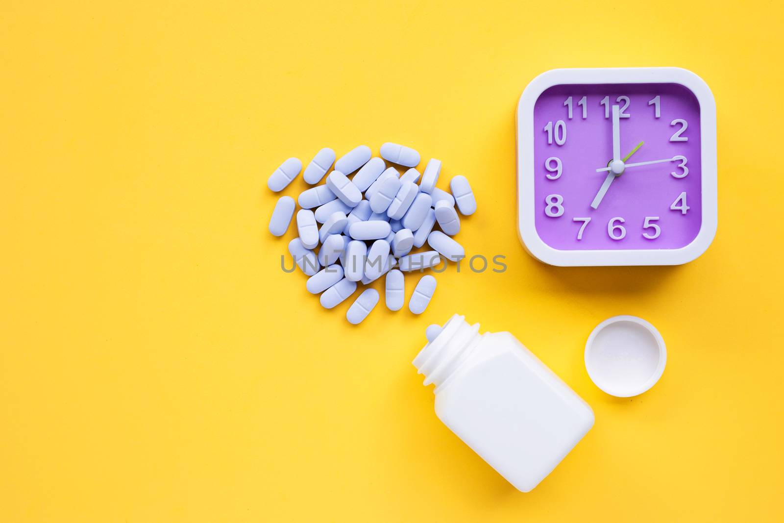 Clock with "PrEP" ( Pre-Exposure Prophylaxis). used to prevent HIV on yellow background. Copy space