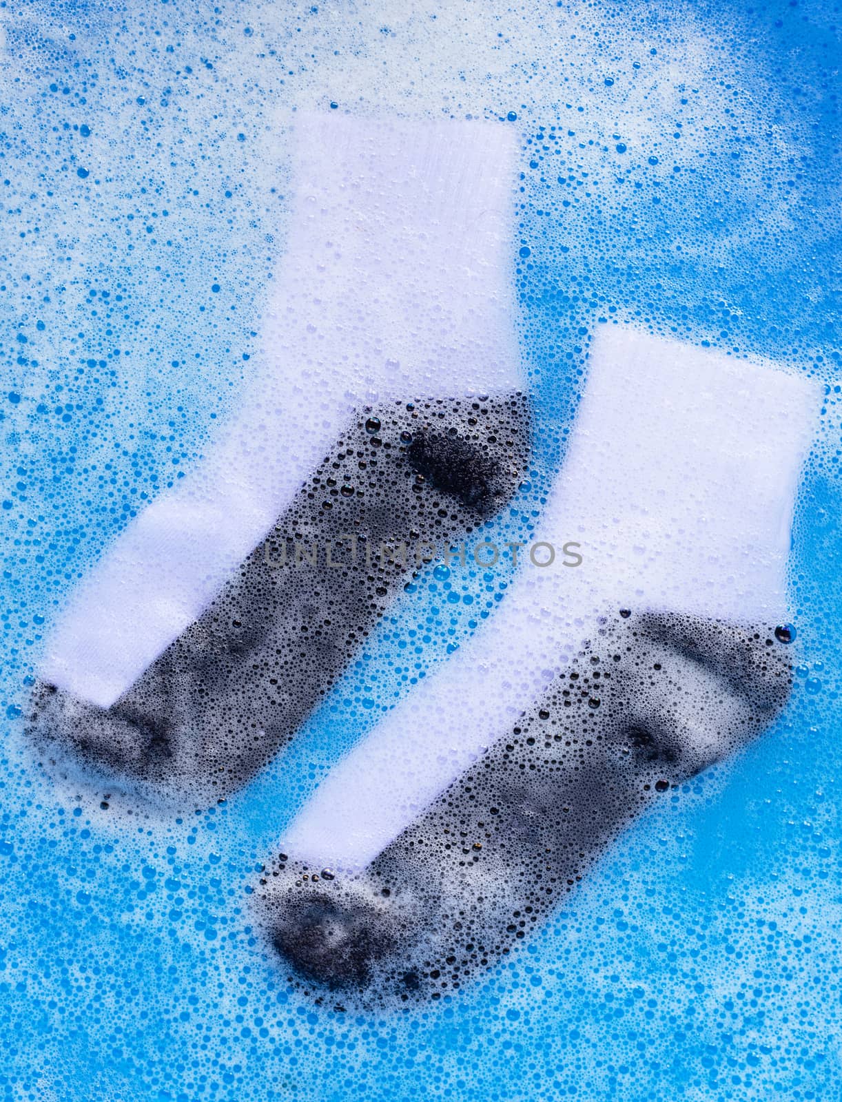 Dirty socks soaking in powder detergent water dissolution.  by Bowonpat