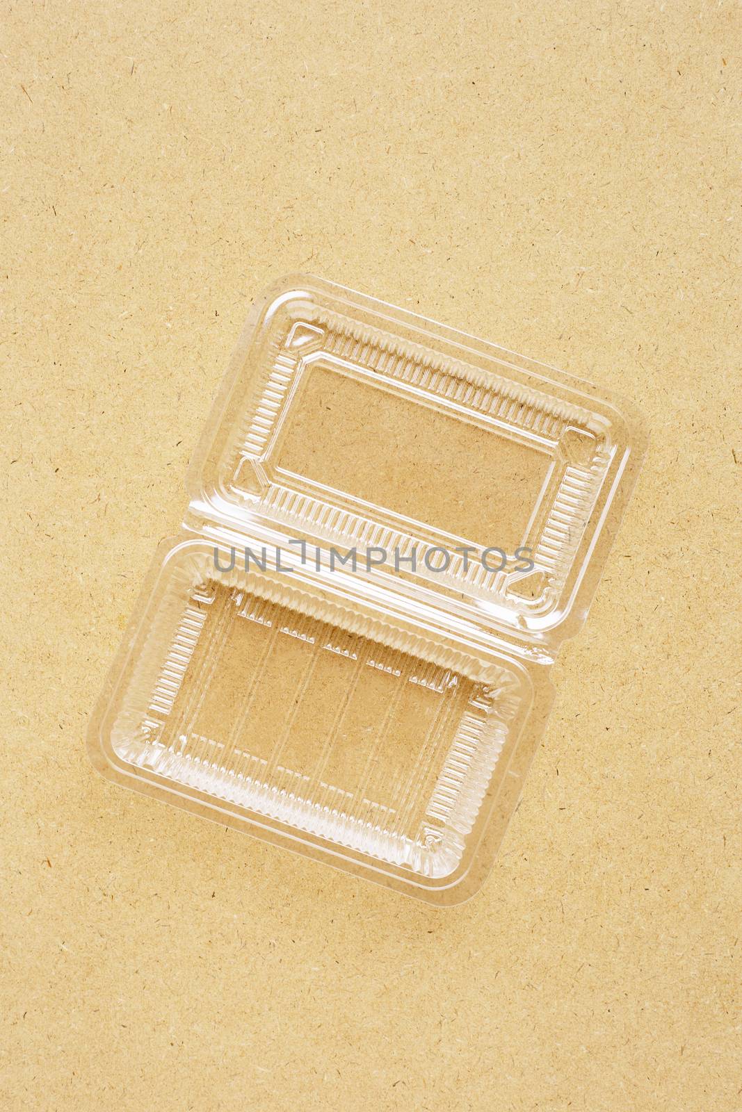 Plastic food container on plywood background.  Copy space