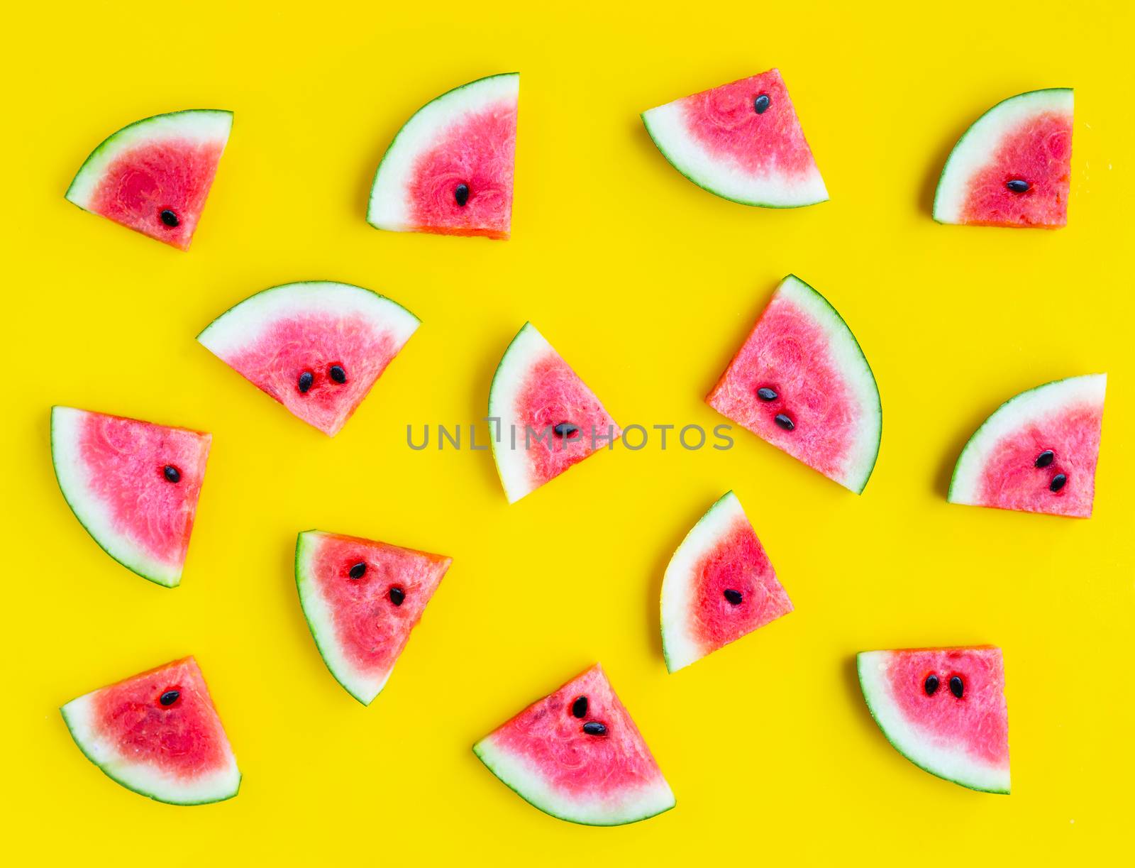 Slices of watermelon on yellow background. Top view