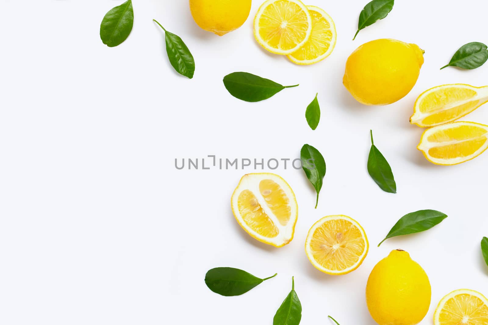 Fresh lemon with green leaves on white background.