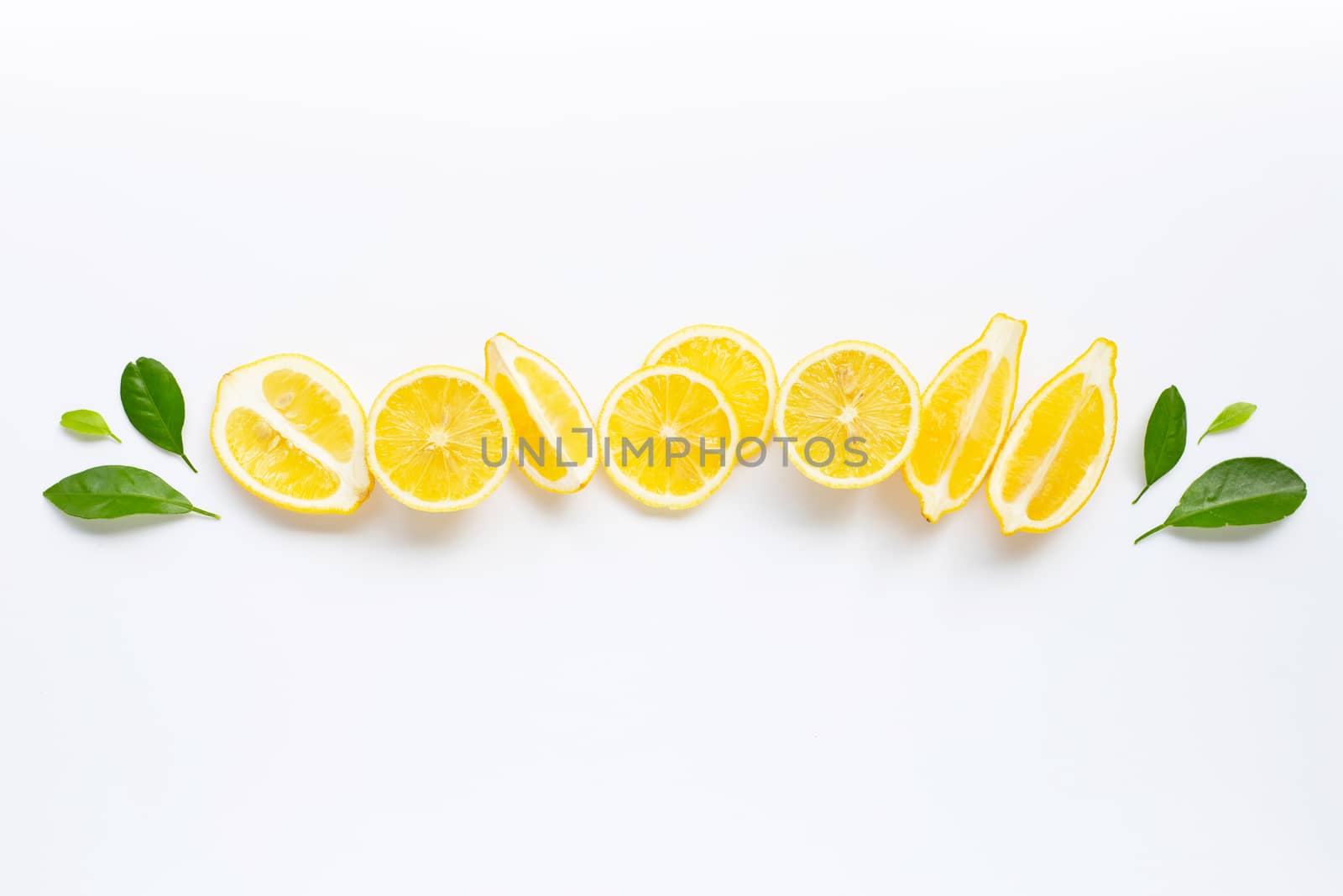 Fresh lemon with green leaves on white background.