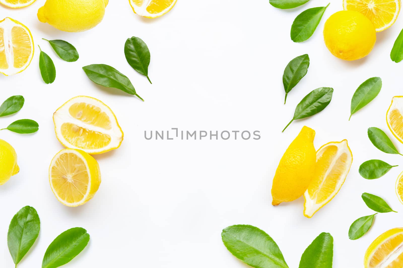 Frame made of fresh lemon with green leaves on white background.
