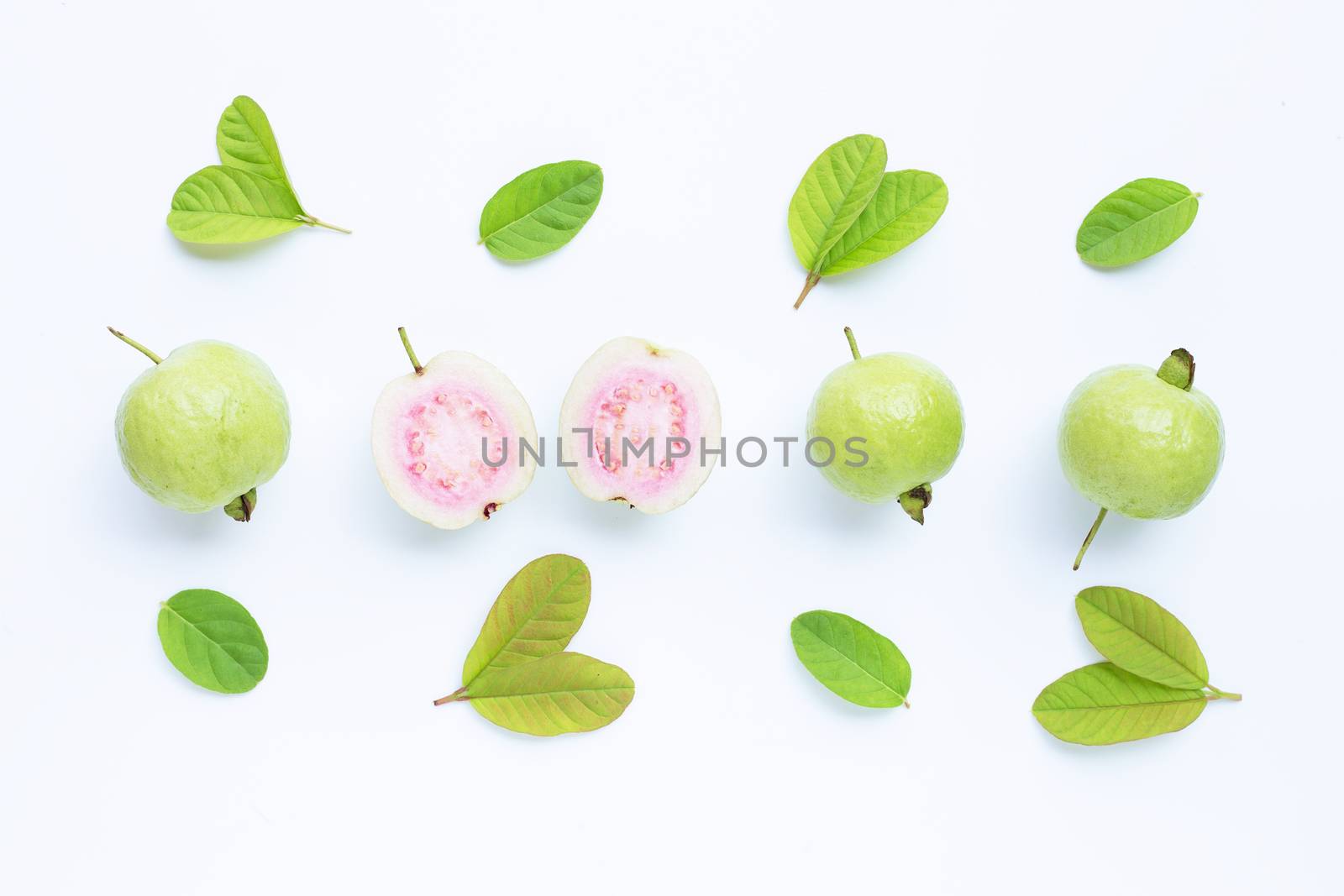 Top view of fresh ripe guava and slices with leaves.
