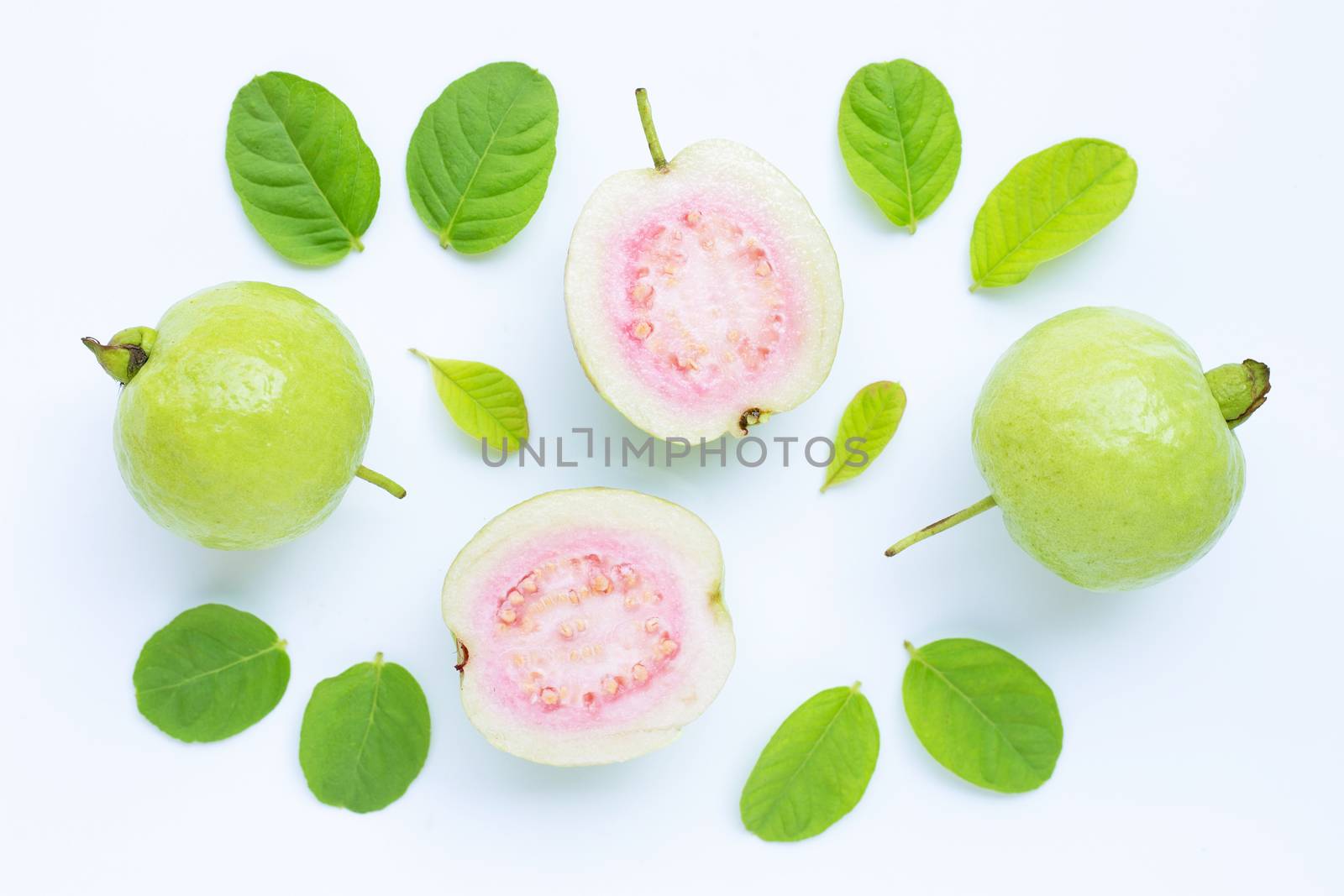 Top view of fresh ripe guava and slices with leaves.