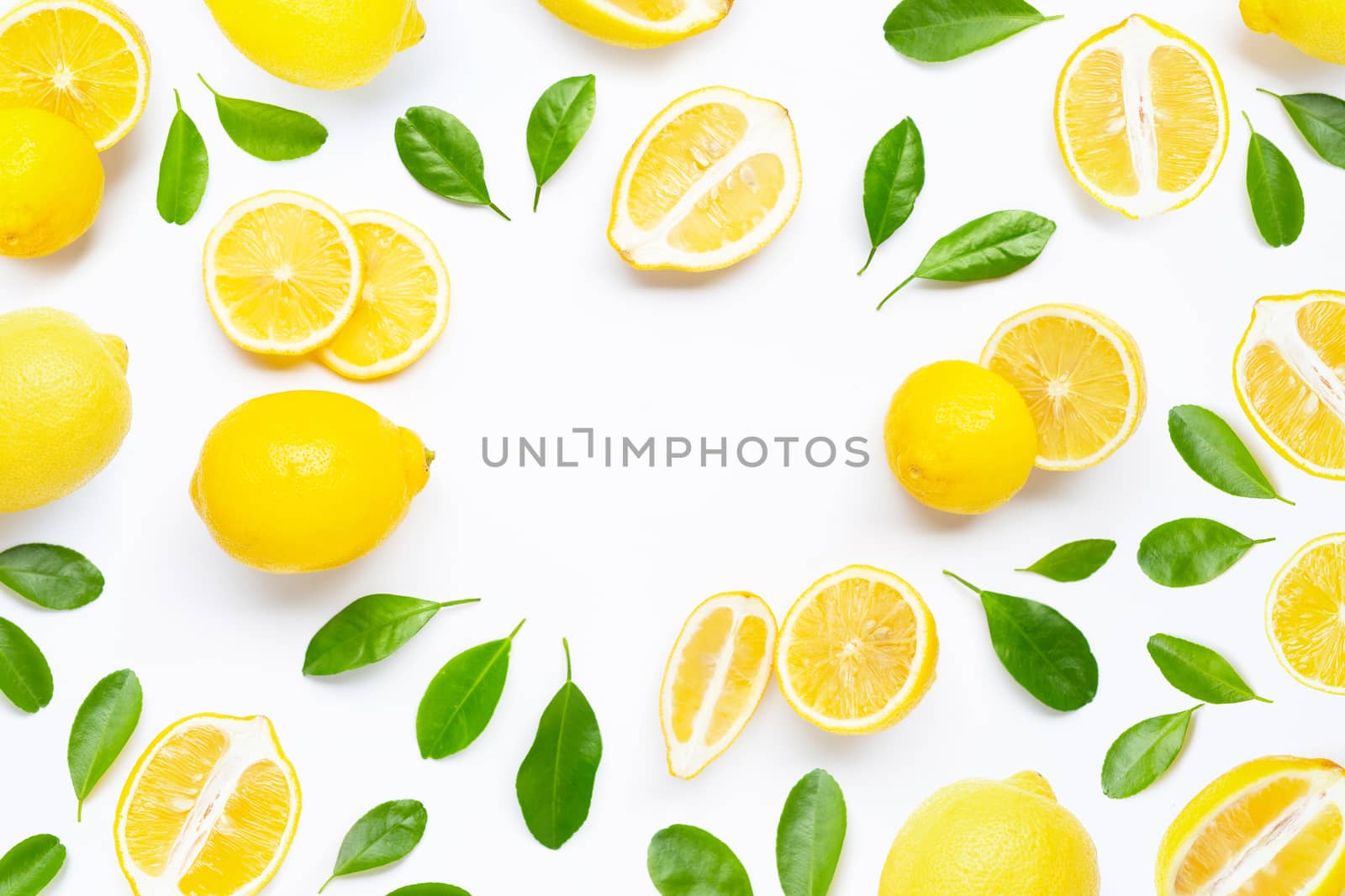 Fresh lemon with green leaves on white background.